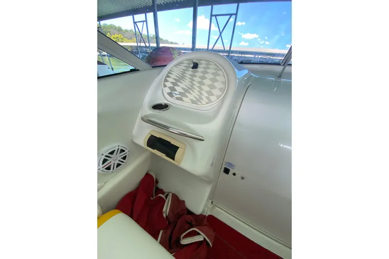 Slide: The Image of Interior of a 1997 Baja 302 Boss boat with checkered dashboard design. - 9