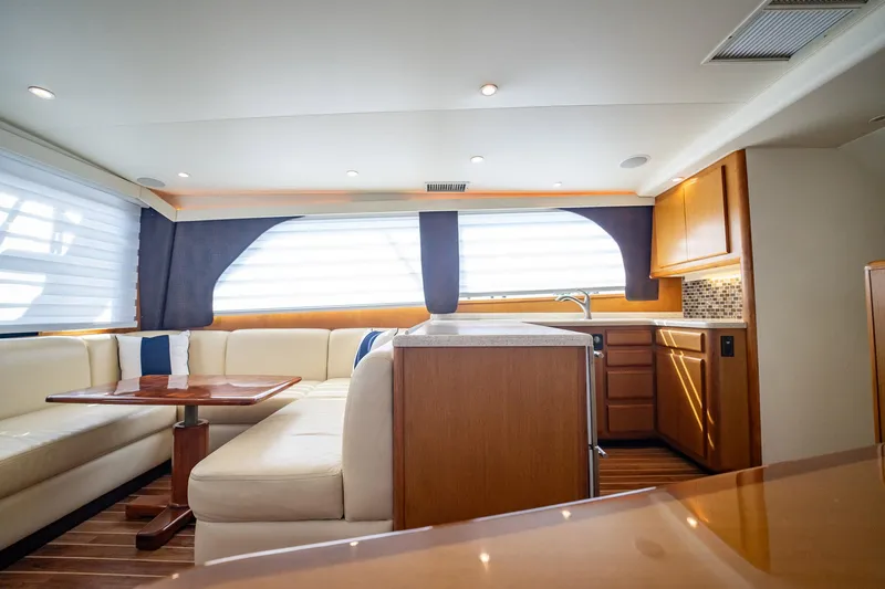 Slide: The Image of Luxurious interior of 2000 Viking 50 Conv Sport Fisher yacht with elegant seating and modern kitchen. - 11