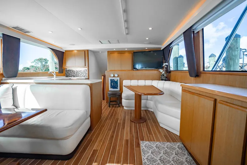 Slide: The Image of Luxurious interior of 2000 Viking 50 Conv Sport Fisher yacht with elegant seating and wood finishes. - 14