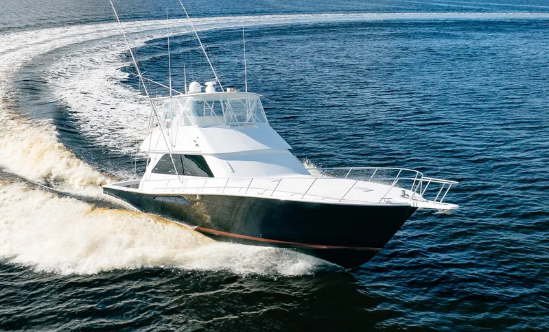 Slide: The Image of Viking 50 Conv Sport Fisher 2000 cruising on open water, creating a dynamic wake. - 2