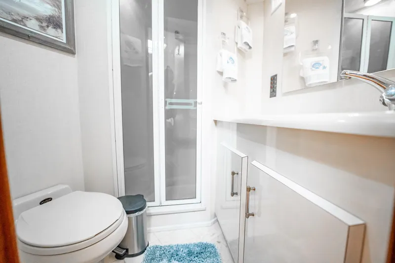 Slide: The Image of Bathroom interior of 2000 Viking 50 Conv Sport Fisher yacht, featuring modern fixtures and shower. - 28