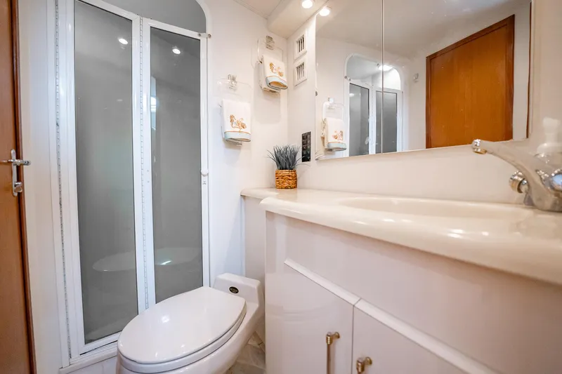Slide: The Image of Bathroom interior of 2000 Viking 50 Conv Sport Fisher yacht, featuring modern fixtures and shower. - 31