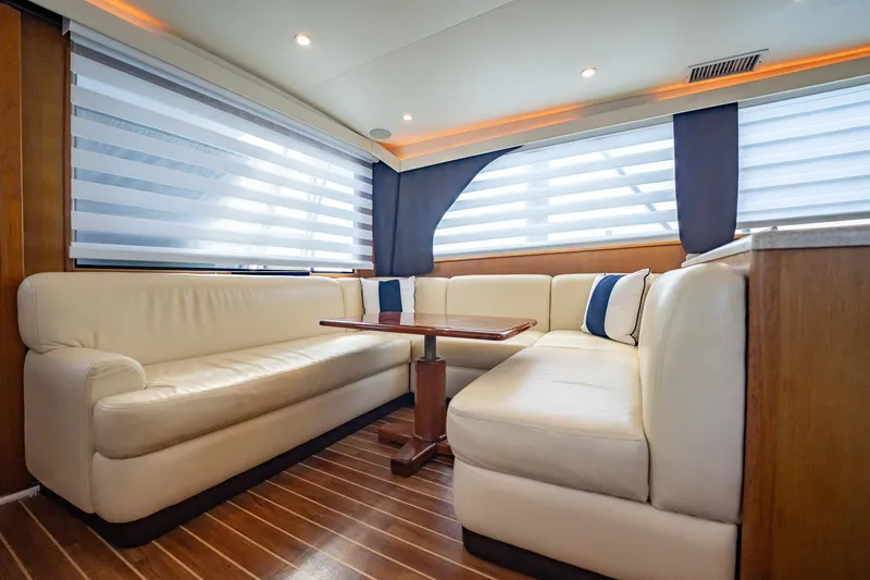 Slide: The Image of Luxurious interior of 2000 Viking 50 Conv Sport Fisher with plush seating and wooden flooring. - 9