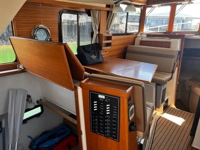 Slide: The Image of Interior of 2022 Ranger Tugs R-31 CB boat with wood finish and seating area. - 10