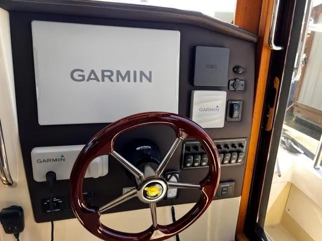 Slide: The Image of Steering wheel and Garmin navigation system on 2022 Ranger Tugs R-31 CB boat. - 19