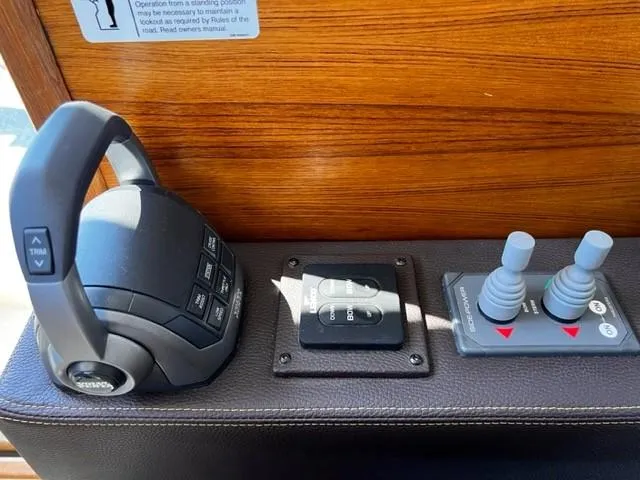 Slide: The Image of Control panel of 2022 Ranger Tugs R-31 CB boat with throttle and joystick controls. - 20