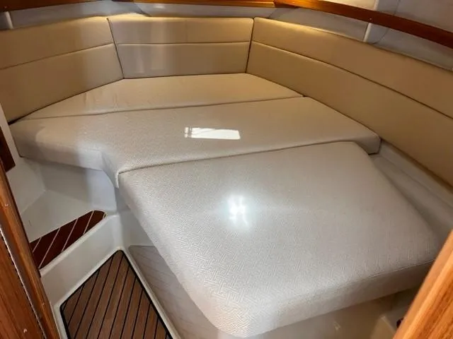 Slide: The Image of 2022 Ranger Tugs R-31 CB interior cabin with beige cushioned seating. - 21