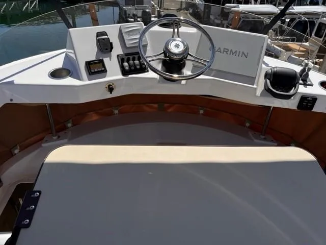Slide: The Image of 2022 Ranger Tugs R-31 CB helm with Garmin navigation system and steering wheel. - 28
