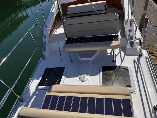 Slide: The Image of 2022 Ranger Tugs R-31 CB boat deck with seating and storage compartments. - 29