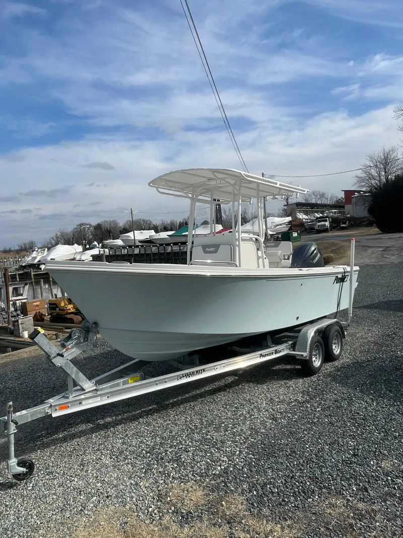 Slide: The Image of 2025 Parker 2100 Special Edition boat on trailer, parked outdoors under a cloudy sky. - 3