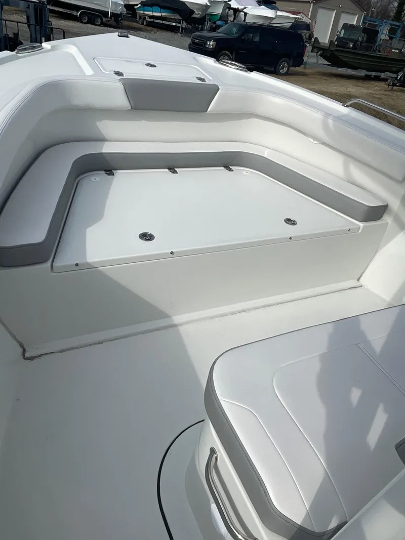 Slide: The Image of 2025 Parker 2100 Special Edition boat interior with white seating and storage compartments. - 6