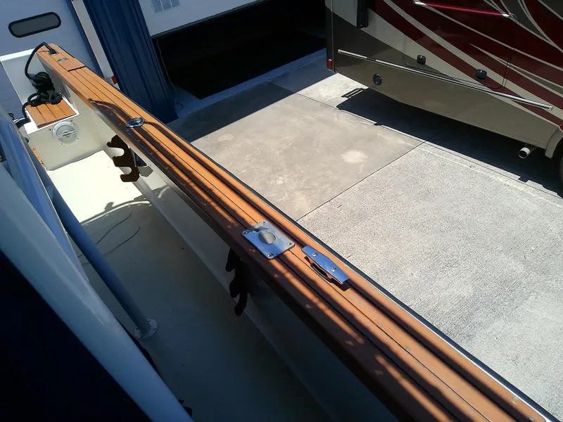 Slide: The Image of 1985 Robalo 2520 Center Console boat with wooden rail detail. - 25