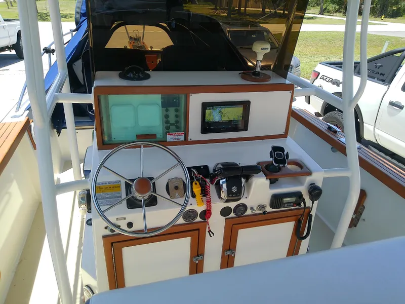 Slide: The Image of 1985 Robalo 2520 Center Console boat dashboard with steering wheel and navigation equipment. - 26