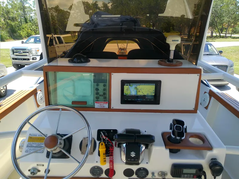 Slide: The Image of 1985 Robalo 2520 Center Console dashboard with steering wheel, navigation equipment, and control panel. - 28
