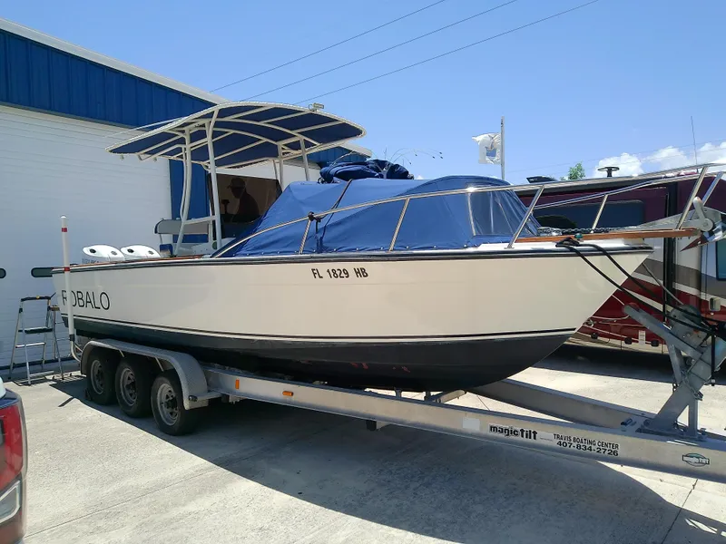 Slide: The Image of 1985 Robalo 2520 Center Console boat on trailer, parked outdoors. - 3