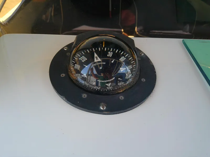 Slide: The Image of Compass on 1985 Robalo 2520 Center Console boat dashboard. - 33