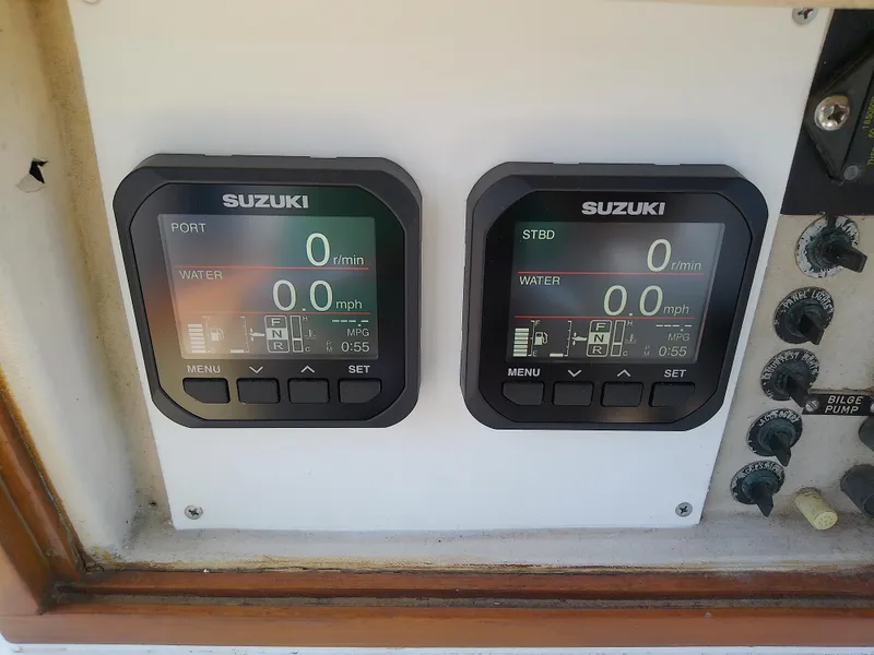 Slide: The Image of Suzuki digital gauges on 1985 Robalo 2520 Center Console boat dashboard. - 34