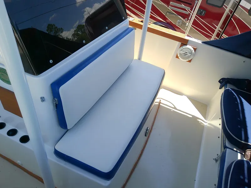 Slide: The Image of 1985 Robalo 2520 Center Console boat interior with cushioned seating and storage. - 42