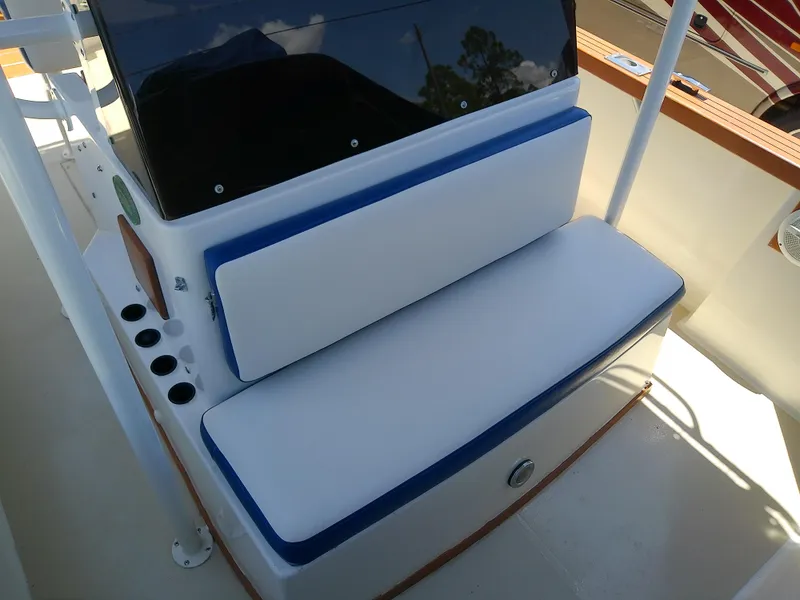 Slide: The Image of 1985 Robalo 2520 Center Console boat seating with blue and white cushions. - 46