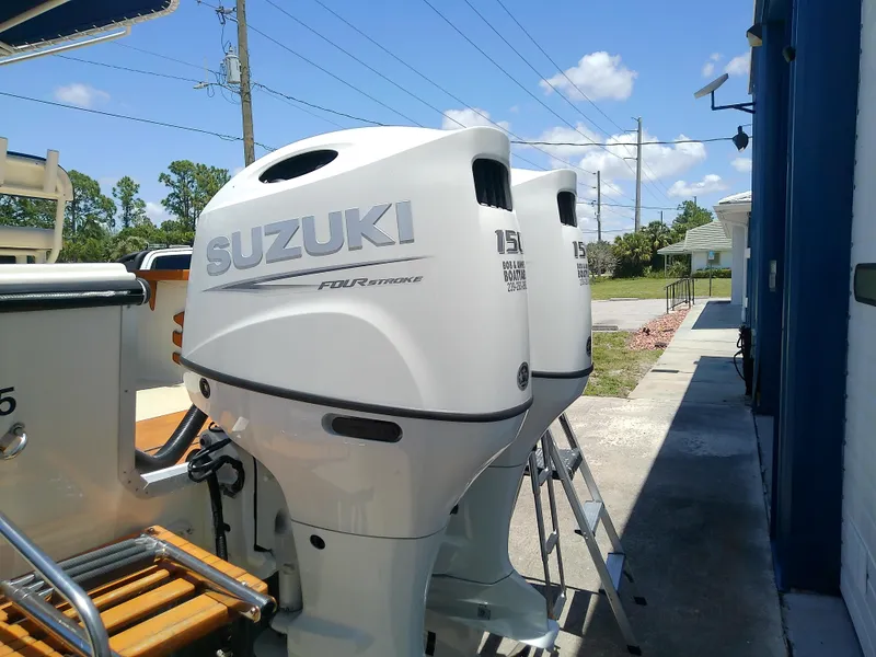 Slide: The Image of Twin Suzuki outboard motors on a 1985 Robalo 2520 Center Console boat. - 5