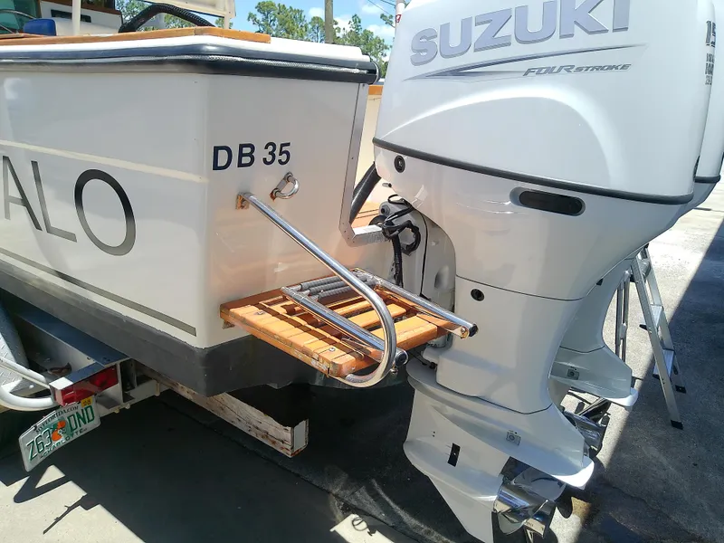 Slide: The Image of 1985 Robalo 2520 Center Console with Suzuki outboard motor and wooden swim platform. - 7