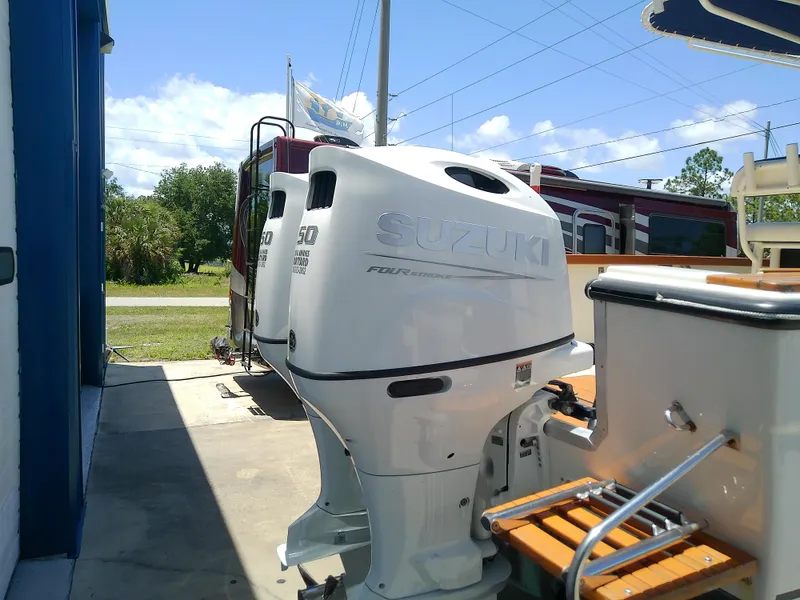 Slide: The Image of Twin Suzuki outboard motors on a 1985 Robalo 2520 Center Console boat. - 8