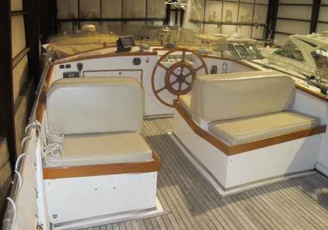 Slide: The Image of 1983 Grand Banks 36 Classic yacht interior with wooden accents and cushioned seating. - 3