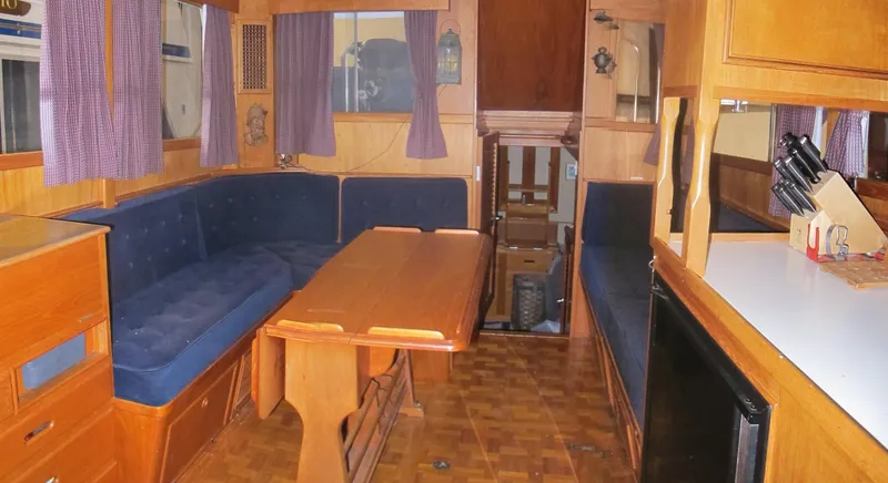 Slide: The Image of Interior of 1983 Grand Banks 36 Classic yacht with wooden furnishings and blue seating. - 7