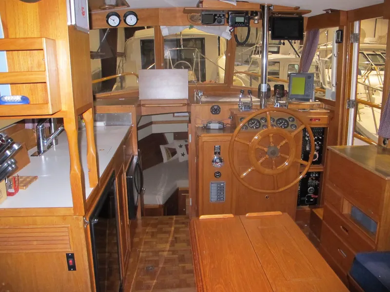 Slide: The Image of Interior of 1983 Grand Banks 36 Classic yacht with wooden helm and galley area. - 8