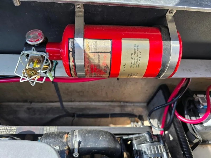 Slide: The Image of Red fire extinguisher mounted in a 2008 Bryant 246 BR boat engine compartment. - 11