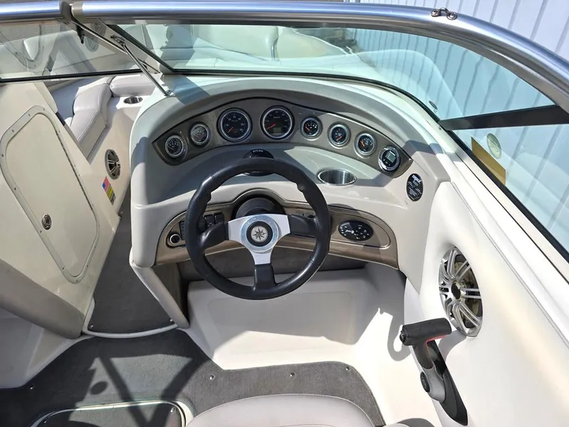 Slide: The Image of 2008 Bryant 246 BR boat dashboard with steering wheel and instrument panel. - 14