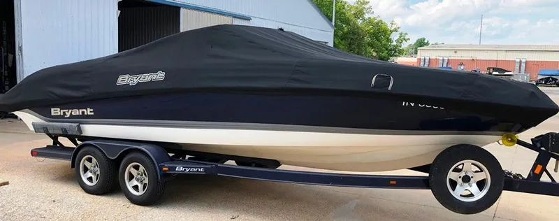 Slide: The Image of 2008 Bryant 246 BR boat on trailer, covered, parked outside a building. - 22
