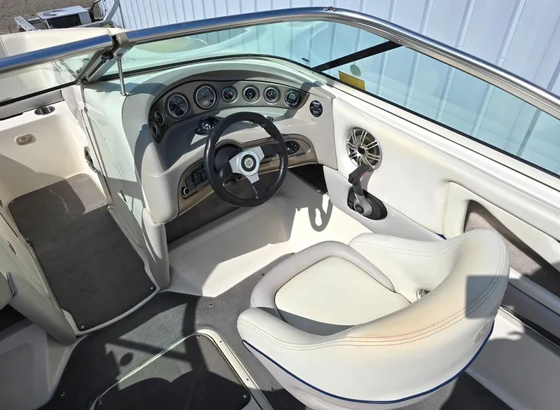 Slide: The Image of 2008 Bryant 246 BR boat interior with steering wheel and dashboard controls. - 3