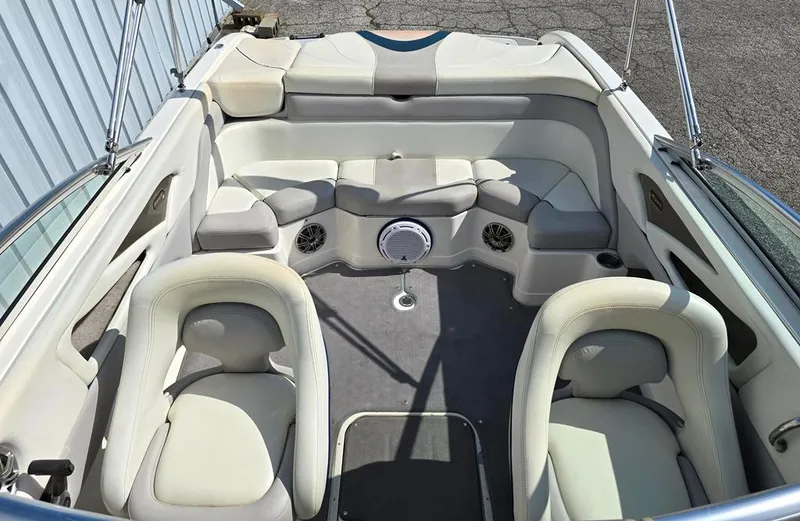 Slide: The Image of 2008 Bryant 246 BR boat interior with white seating and gray flooring. - 5