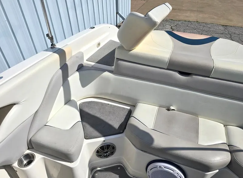 Slide: The Image of Interior seating of a 2008 Bryant 246 BR boat, featuring cushioned seats and speaker. - 6