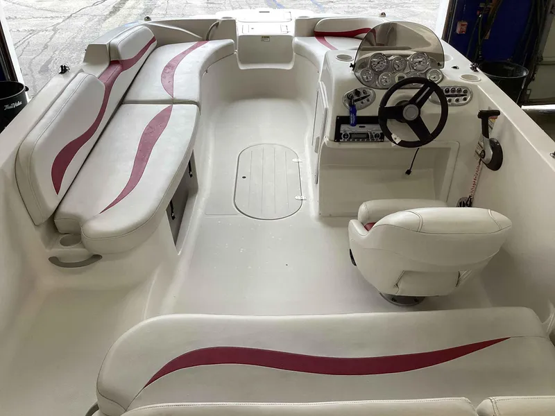 Slide: The Image of 2006 Starcraft SeaStar 2000 boat interior with white and red seating, steering console, and dashboard. - 4