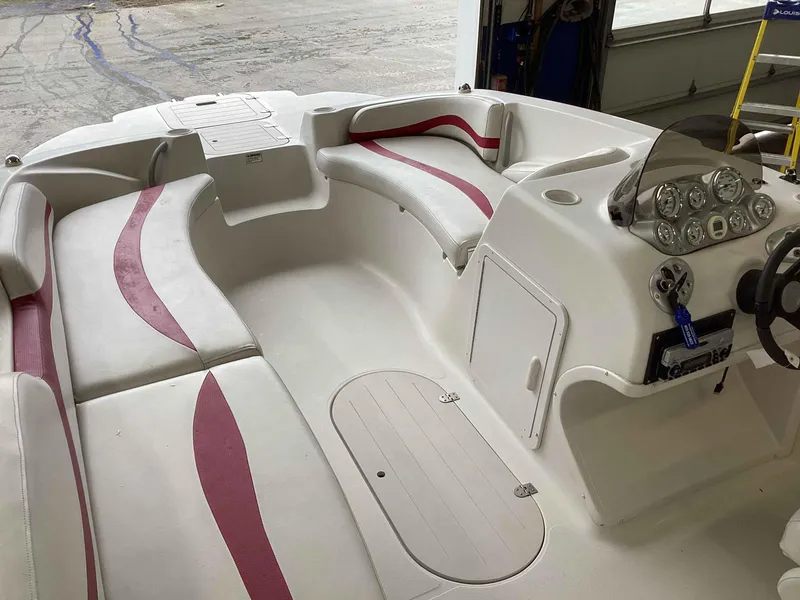 Slide: The Image of 2006 Starcraft SeaStar 2000 boat interior with white and red seating, dashboard, and steering wheel. - 6