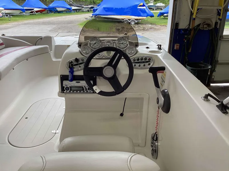 Slide: The Image of 2006 Starcraft SeaStar 2000 boat cockpit with steering wheel and control panel. - 8