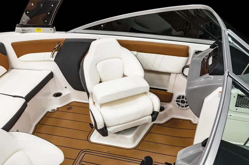 Slide: The Image of 2025 Chaparral 21 SSi boat interior with white seating and brown accents. - 11