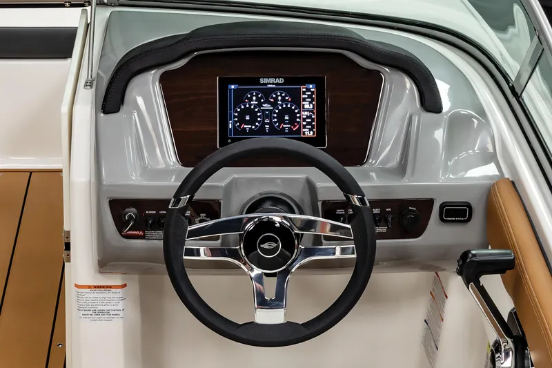 Slide: The Image of 2025 Chaparral 21 SSi boat dashboard with steering wheel and digital display. - 17