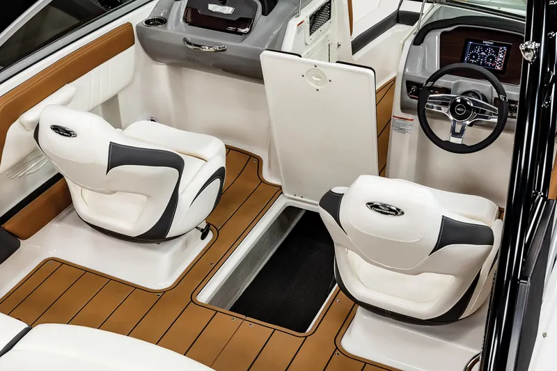 Slide: The Image of 2025 Chaparral 21 SSi boat interior with modern seating and sleek dashboard design. - 18
