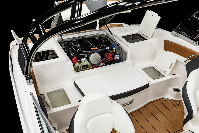Slide: The Image of 2025 Chaparral 21 SSi boat interior with open engine compartment and seating area. - 21