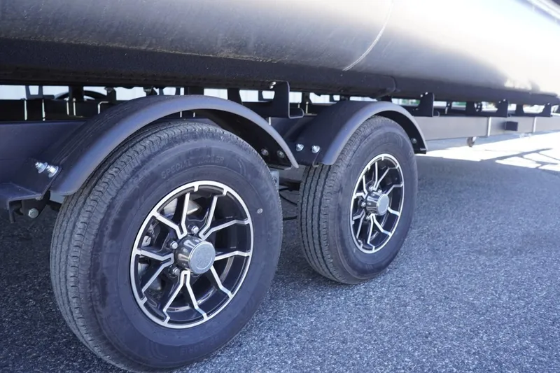 Slide: The Image of Trailer wheels of a 2025 Lowe SS 230 on asphalt surface. - 13