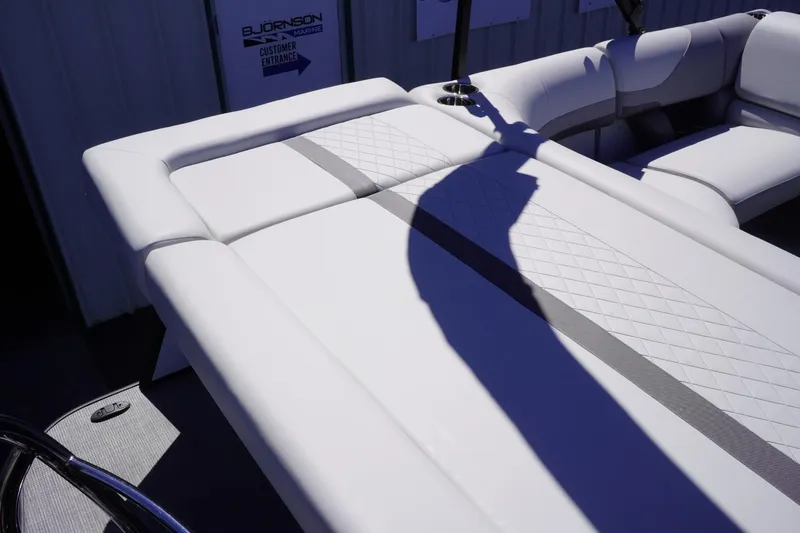 Slide: The Image of 2025 Lowe SS 230 boat interior with white cushioned seating and modern design. - 16