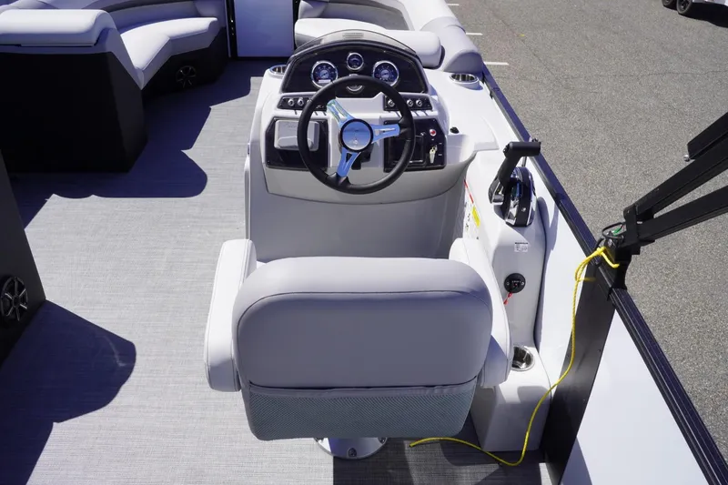 Slide: The Image of 2025 Lowe SS 230 boat interior with steering wheel and control panel. - 19