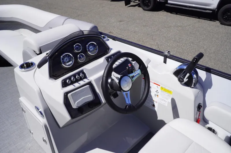 Slide: The Image of 2025 Lowe SS 230 boat dashboard with steering wheel and control panel. - 20