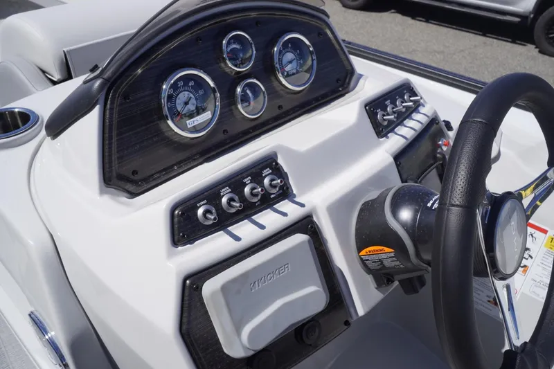 Slide: The Image of Control panel of 2025 Lowe SS 230 boat with gauges and steering wheel. - 22