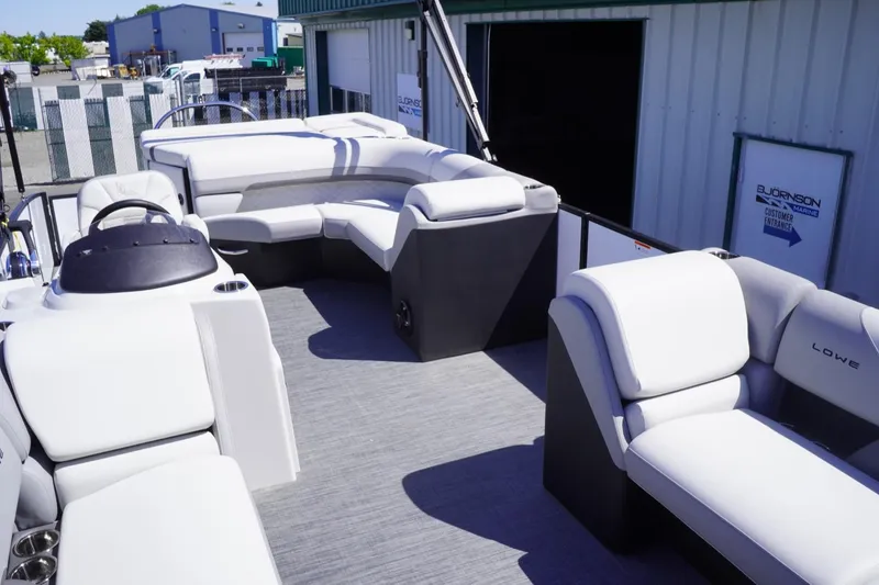 Slide: The Image of 2025 Lowe SS 230 pontoon boat interior with plush seating and modern design. - 30