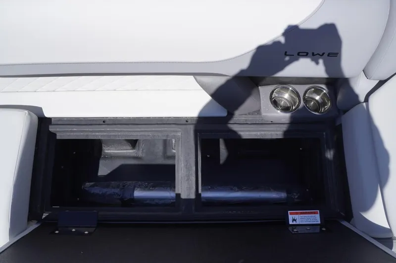 Slide: The Image of Interior of 2025 Lowe SS 230 boat with storage compartment and cup holders. - 31