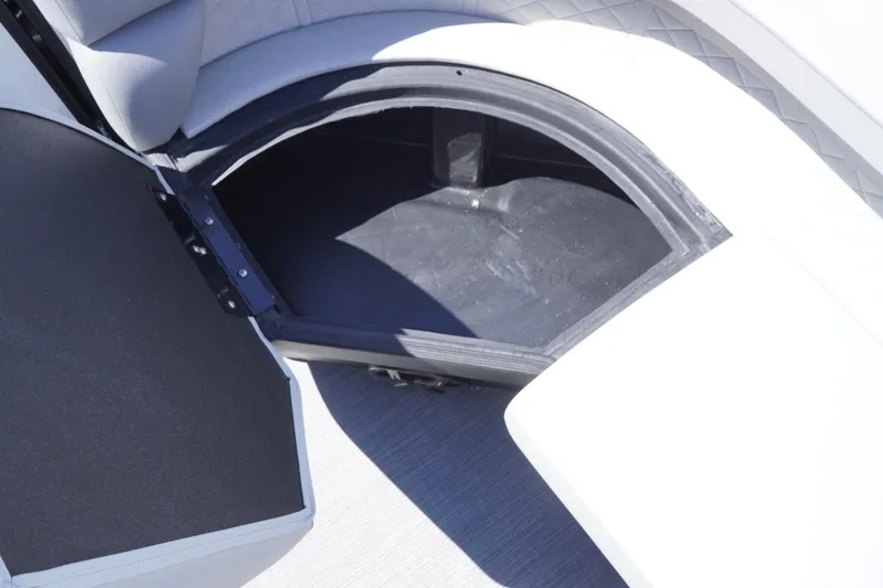 Slide: The Image of Open storage compartment in 2025 Lowe SS 230 boat, featuring sleek seating design. - 32